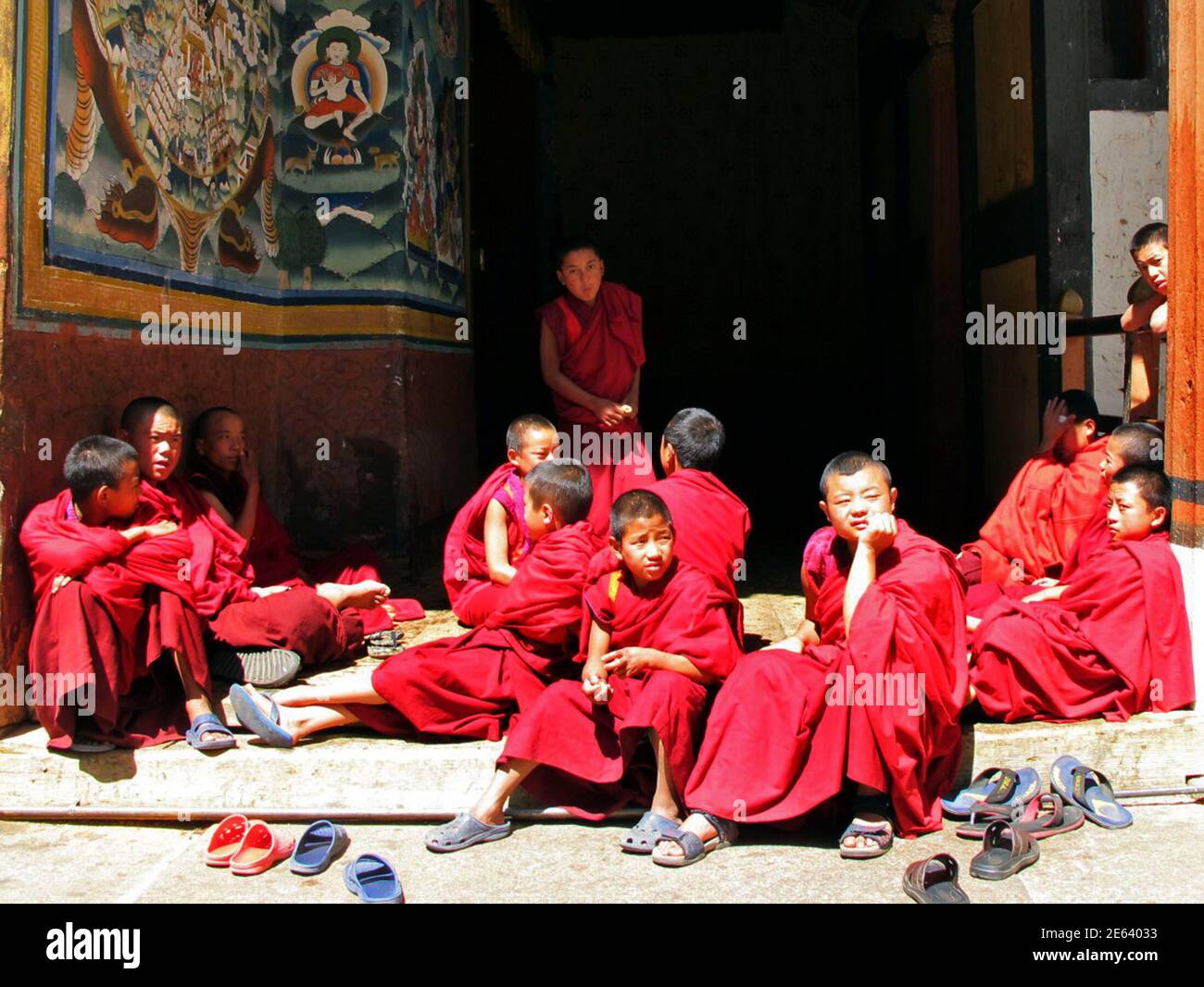 Young Buddhist monks take a break at Rinpung Dzong monastery in Paro Valley, Bhutan March 11, 2011. The Himalayan kingdom of Bhutan is becoming increasingly popular for well-heeled travelers keen to explore this remote and unspoiled Buddhist Shangri La. Surrounded by mountains and flanked by India and Tibet, this tiny country has only been opened to tourism for a few decades and its traditional way of life remains miraculously preserved despite the growing prevalence of mobile phones and cable television. Paro Dzong (Rinpung Dzong) is an enormous fortress-monastery built in 1646 which featured Stock Photo