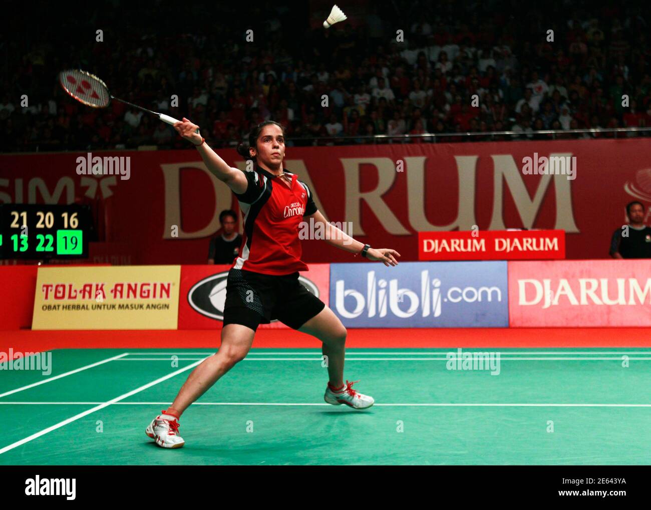 Saina Nehwal of India returns a shot to China's Li Xuerui during their  women's single match at the final of Djarum Indonesia Open badminton  tournament in Jakarta June 17, 2012. REUTERS/Beawiharta (INDONESIA -
