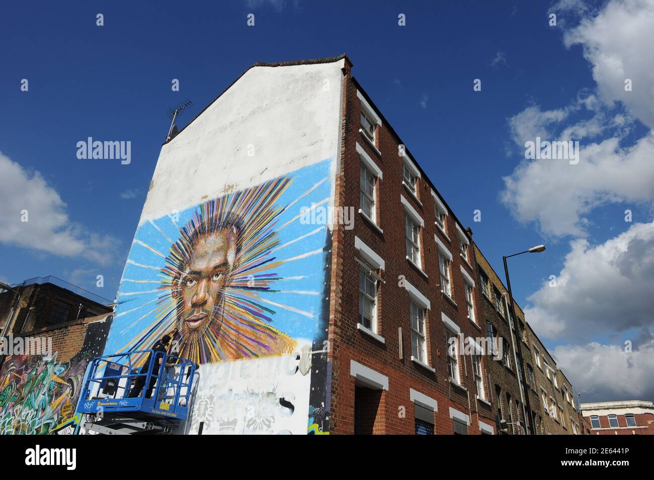 Street artist James Cochran, also known as Jimmy C, works on his spray painted picture of Jamaican sprinter Usain Bolt in Sclater street car park in east London July 19, 2012. Cochran said this was done as an homage to the London 2012 Olympic Games, which begin July 27. REUTERS/Paul Hackett (BRITAIN - Tags: SPORT OLYMPICS ATHLETICS ENTERTAINMENT) Stock Photo