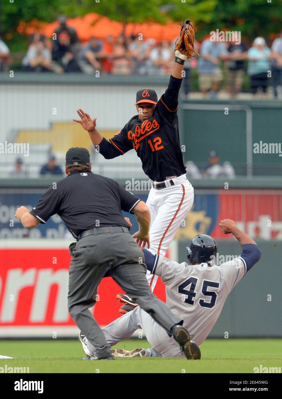 Baltimore Orioles second baseman Alexi Casilla leaps for the throw but can't get the tag down in time to catch New York Yankees baserunner Zoilo Almonte on a stolen base during the second inning of their MLB American League baseball game in Baltimore, Maryland June 28, 2013.  REUTERS/Doug Kapustin (UNITED STATES - Tags: SPORT BASEBALL) Stock Photo