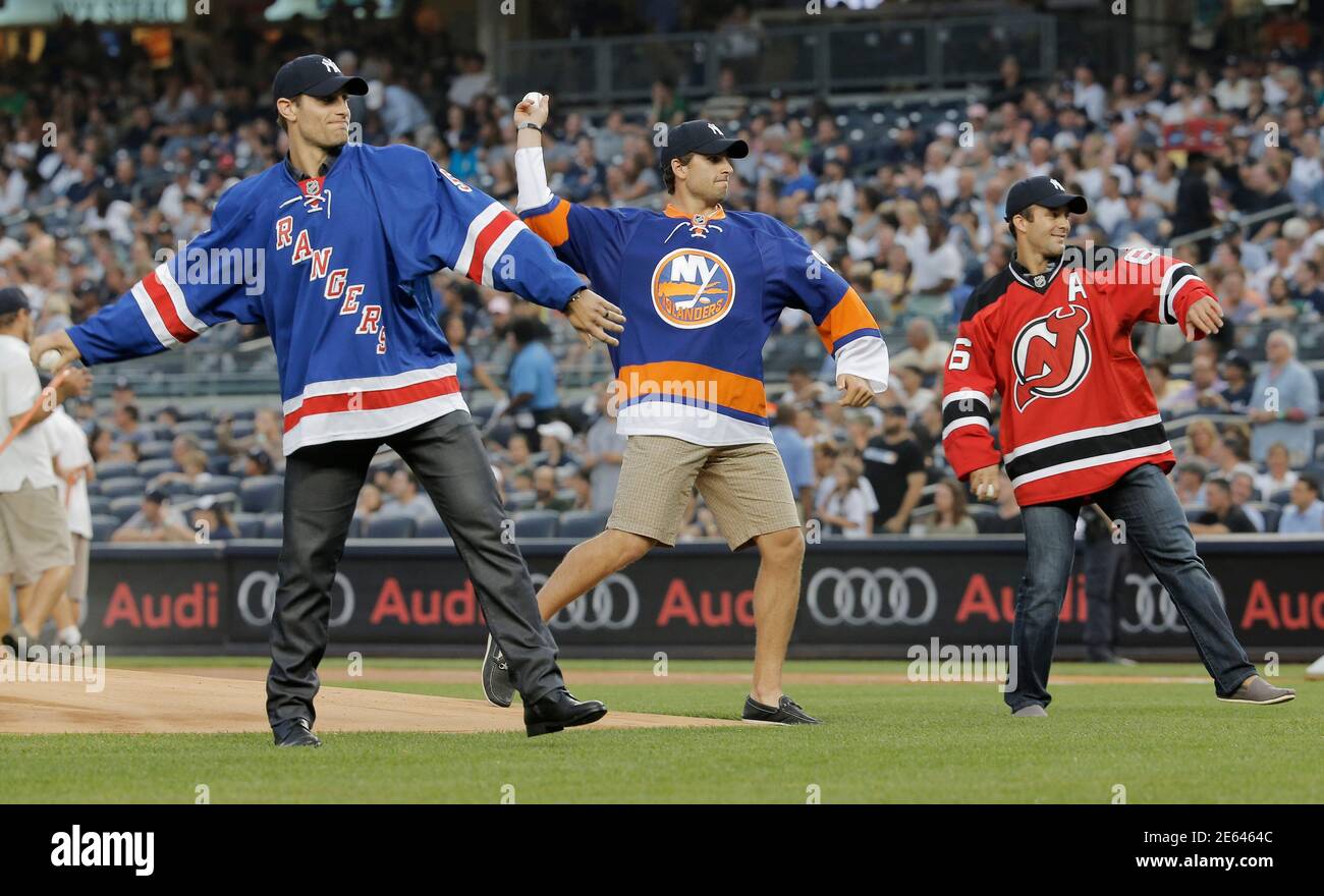 From L-R: New York Rangers' Dan Girardi, New York Islanders' John Tavares  and New Jersey Devils' Andy Greene throw out the ceremonial first pitch  before the New York Yankees play the Detroit