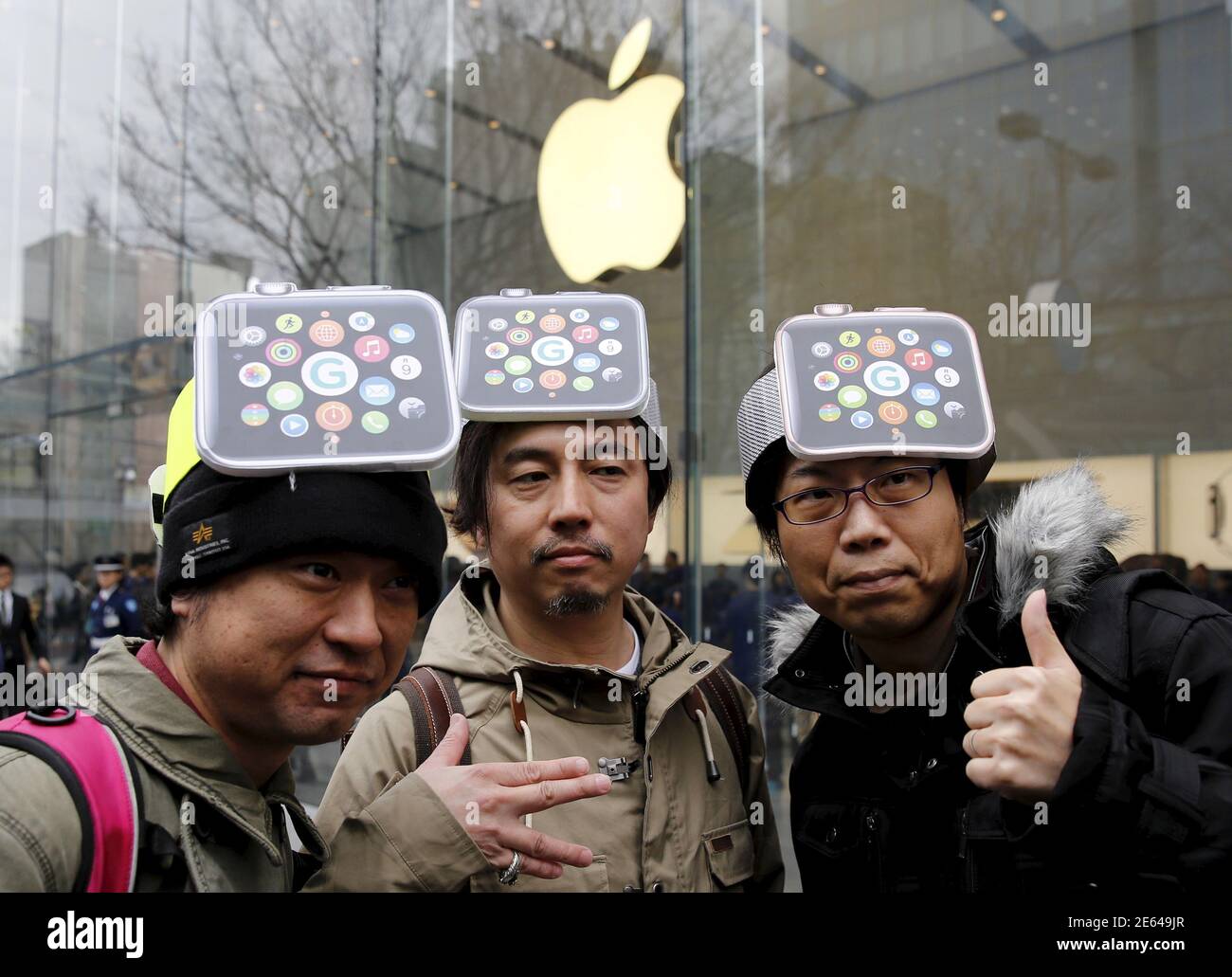 Men wearing cardboard hats depicting 