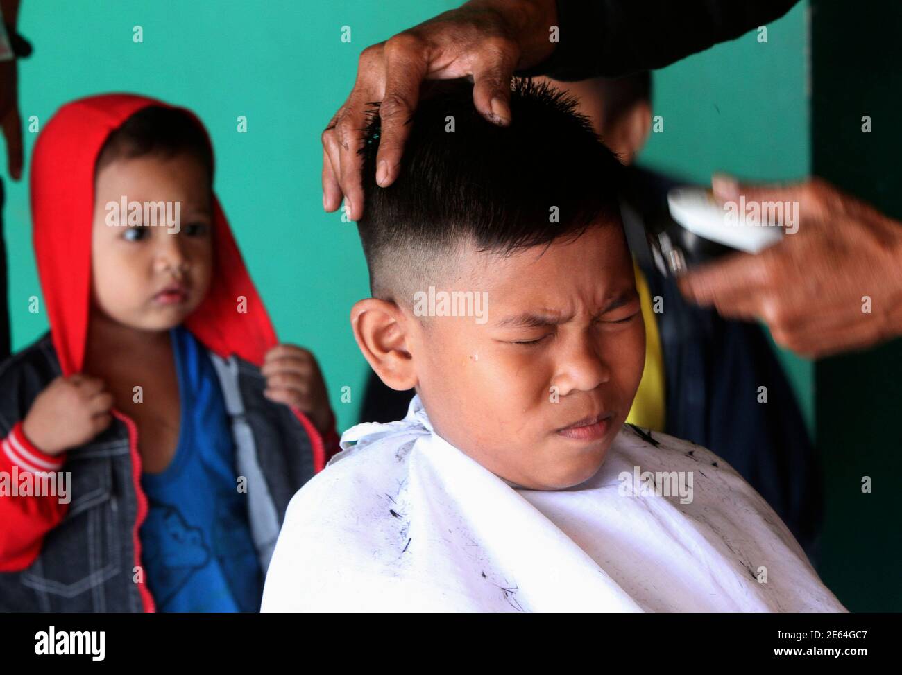 A Muslim boy reacts as he gets a free haircuts during the Muslim holiday in  celebration Maulidin Nabi or the birth of Prophet Muhammad in Taguig city,  south of Manila February 6,