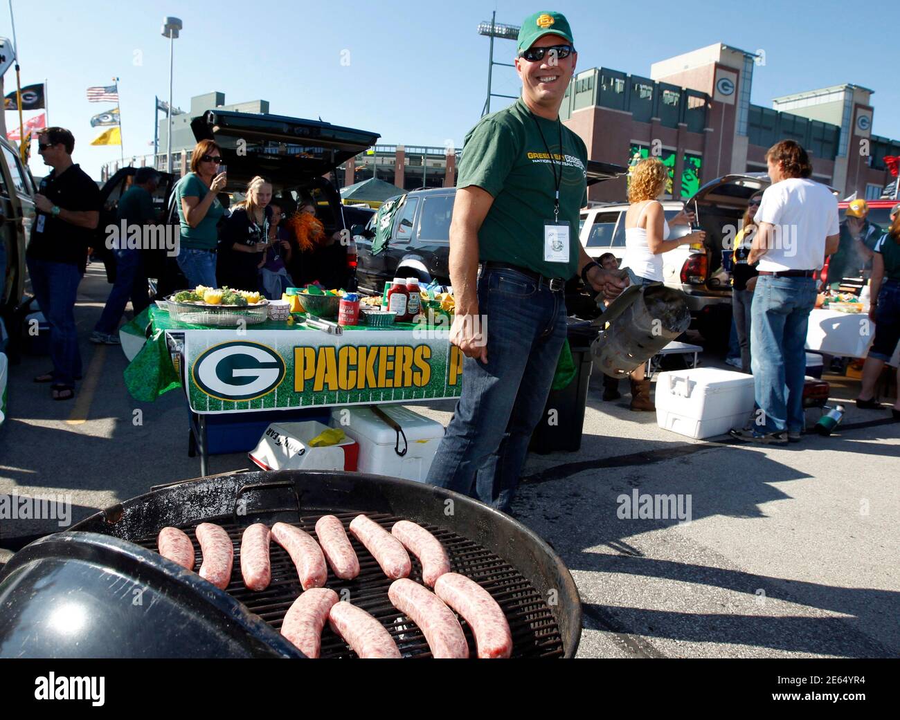 A Green Bay Packers fan grills bratwurst in the parking lot at Lambeau  Field before the start of the team's NFL football game in Green Bay,  Wisconsin, September 8, 2011. REUTERS/Jeff Haynes (
