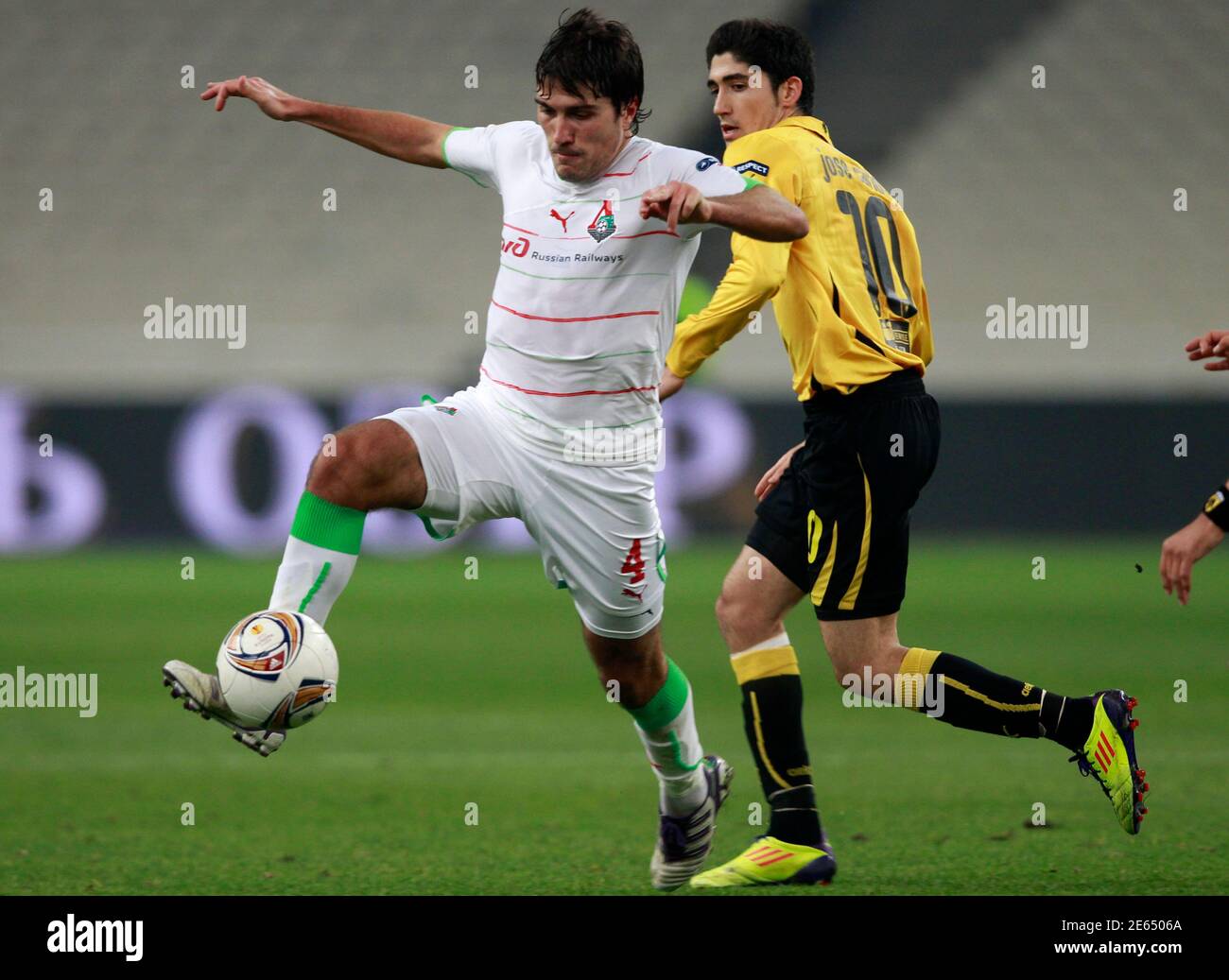 Lokomotiv Moscow's Alberto Zapater (L) controls the ball in front of AEK  Athens' Jose Carlos during their Europa League Group L soccer match at  Olympic stadium in Athens November 3, 2011. REUTERS/John