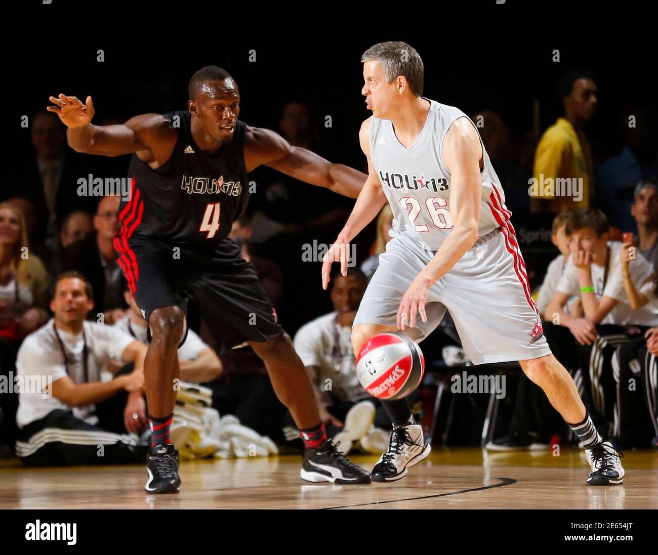 Jamaican sprinter Usain Bolt (L) guards U.S. Secretary of Education Arne  Duncan (R) during the NBA All-Star celebrity basketball game in Houston,  Texas, February 15, 2013. The NBA All-Star basketball game will
