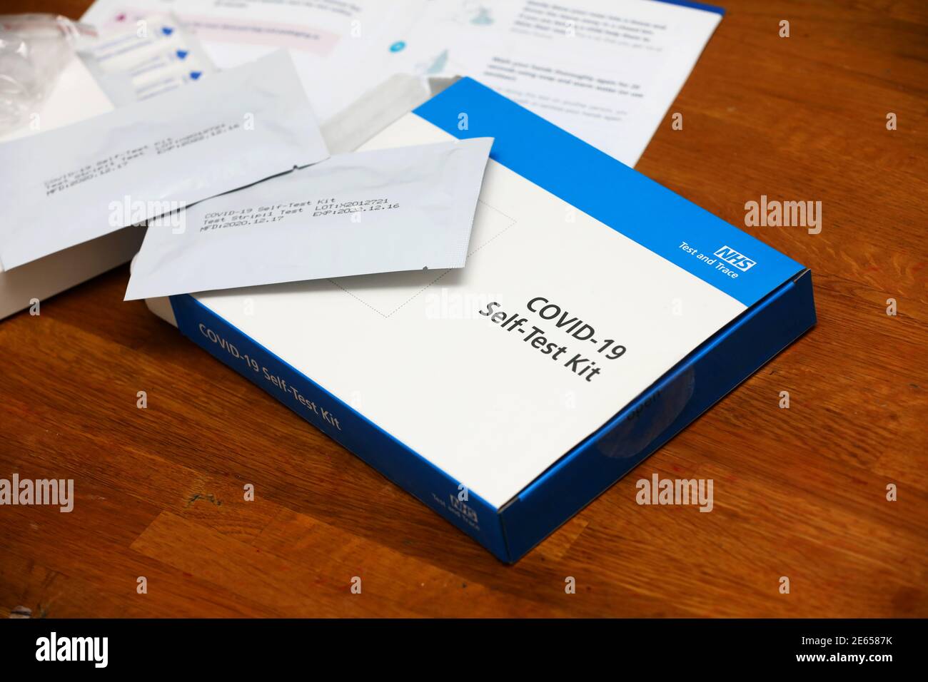 A teacher holding a COVID-19 Self-Test Kit in her home in Sussex, UK. Stock Photo