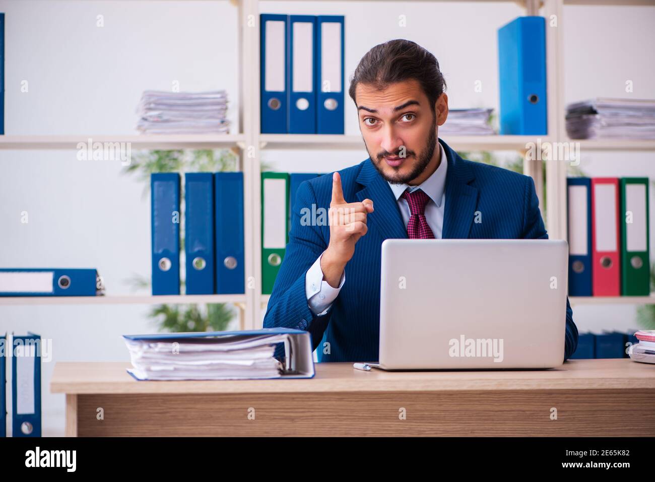 Young employee and too many work in the office Stock Photo - Alamy