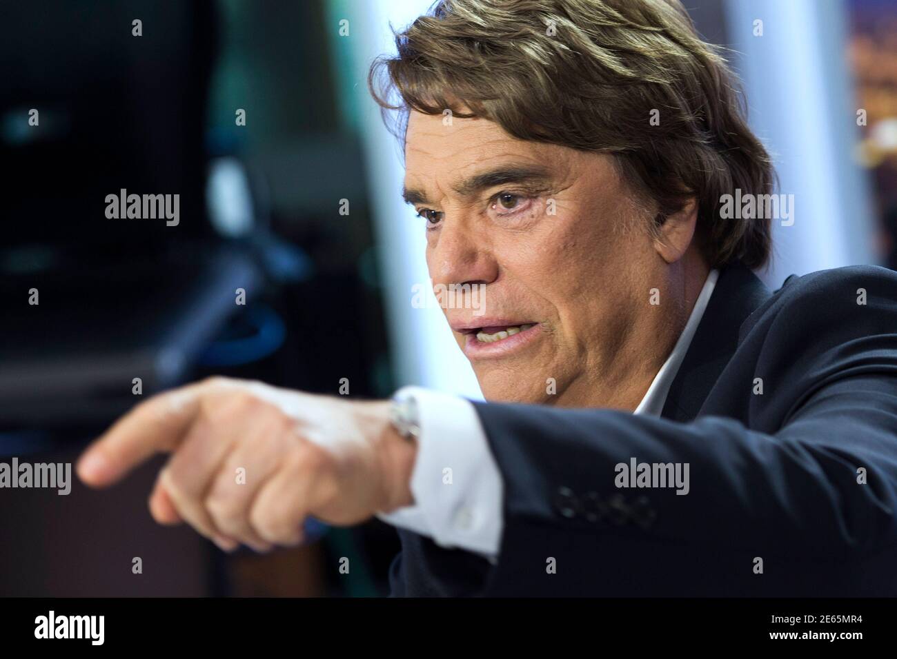 French businessman Bernard Tapie gestures as he attends the French channel France  2 news evening broadcast in Paris July 1, 2013. Tapie was put under formal  investigation on suspicion of fraud on