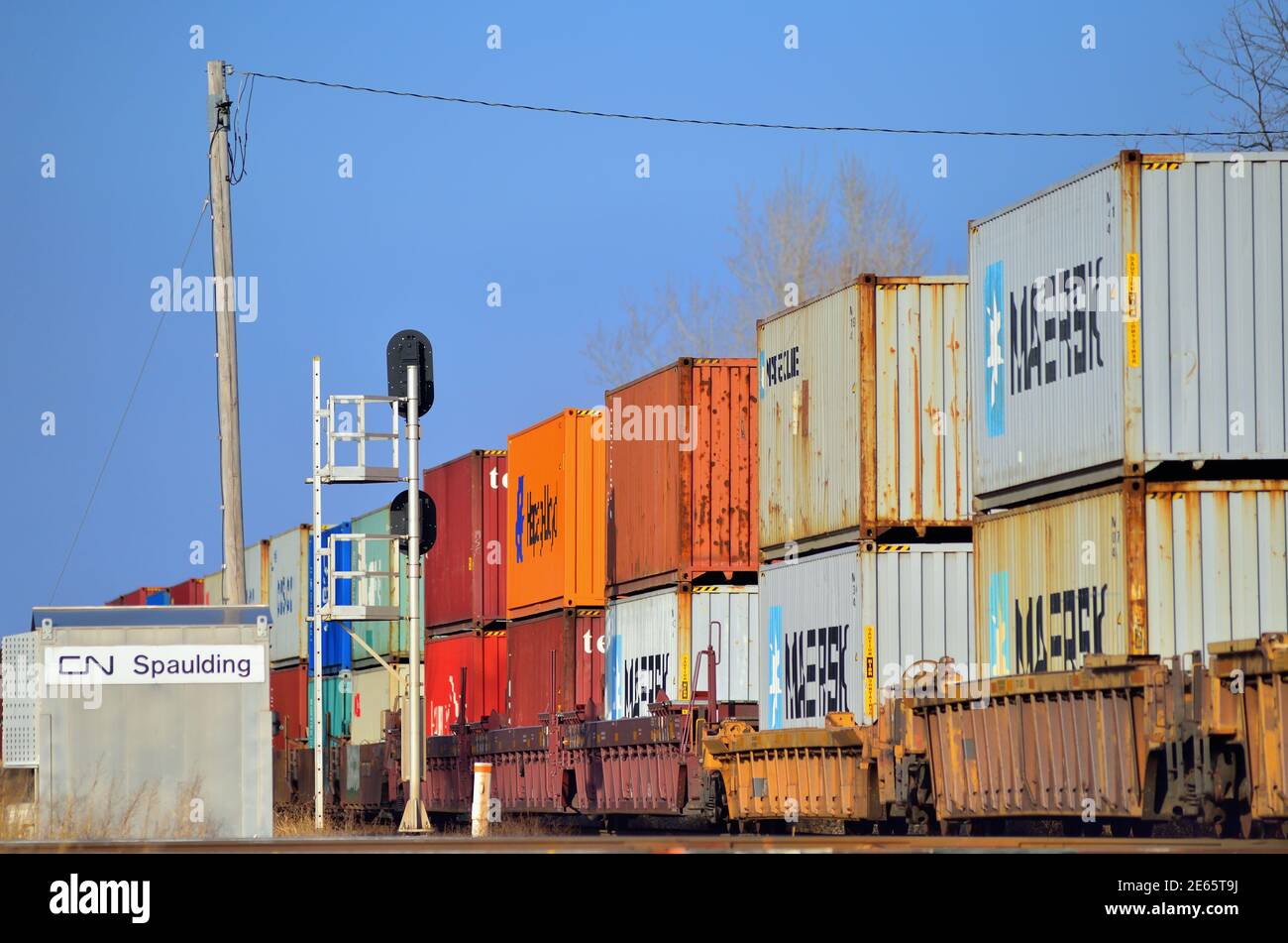Bartlett, Illinois, USA. A Canadian National intermodal freight train as it is crosses the Metra tracks also shared by the Canadian Pacific Railway. Stock Photo
