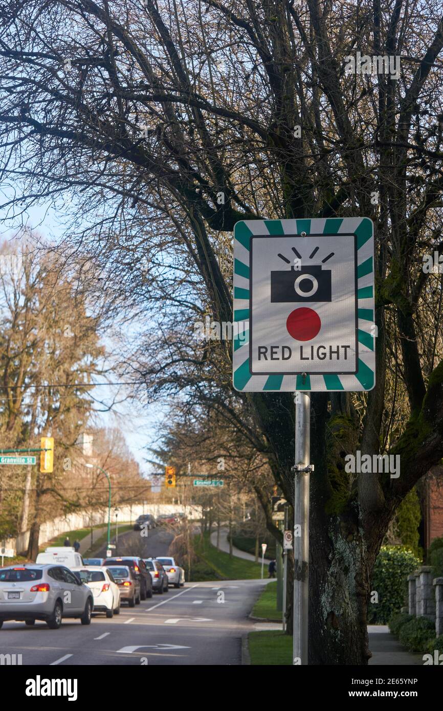 Red light camera sign by the side of a busy street in Vancouver, British Columbia, Canada Stock Photo