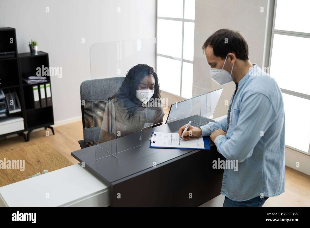 Hotel Reception Desk Protected By Medical Mask From Covid 19 Stock