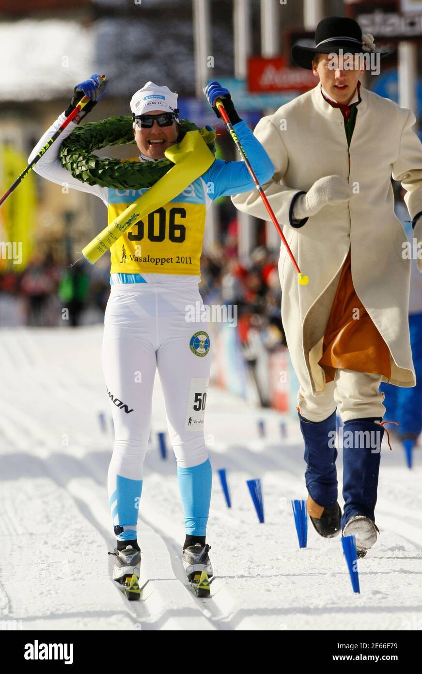 Jenny Hansson of Sweden celebrates winning the women's race of the 87th  Vasaloppet long distance cross country ski race with a crown boy in Mora,  Sweden, March 6, 2011. The traditional 90-km (