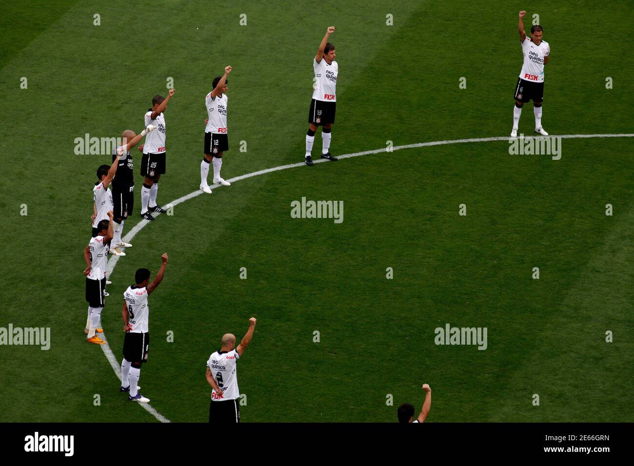 Corinthians soccer players observe a minute's silence for Brazil former soccer player Socrates before their Brazilian championship against Palmeiras in Sao Paulo December 4, 2011. Brazil 1982 World Cup captain Socrates, the 'Golden Heel' renowned as one of the great playmakers of his generation, died in hospital on Sunday of septic shock at the age of 57, his doctors said in a statement. REUTERS/Nacho Doce (BRAZIL - Tags: SPORT SOCCER OBITUARY) Stock Photo
