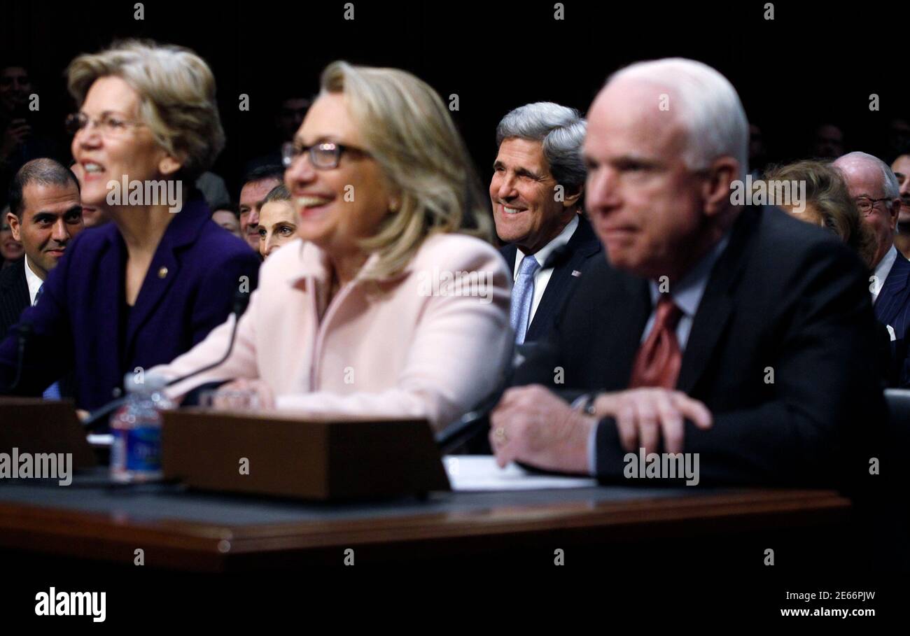 U.S. Senator John Kerry (D-MA) (2ndR) listens as he is ...