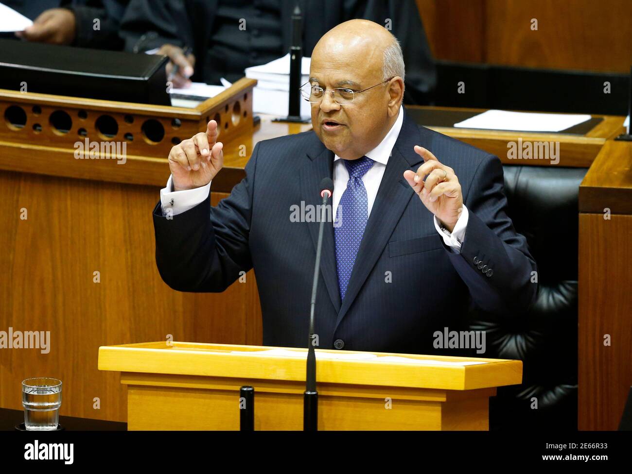 South Africa's Finance Minister Pravin Gordhan delivers his 2014 budget address in Parliament in Cape Town February 26, 2014. South Africa cut this year's growth forecast to 2.7 percent, saying deep challenges persisted after a 2009 recession and warning that delays to new infrastructure, especially in the power sector, posed risks to the continent's largest economy. REUTERS/Mike Hutchings (SOUTH AFRICA - Tags: POLITICS BUSINESS) Stock Photo