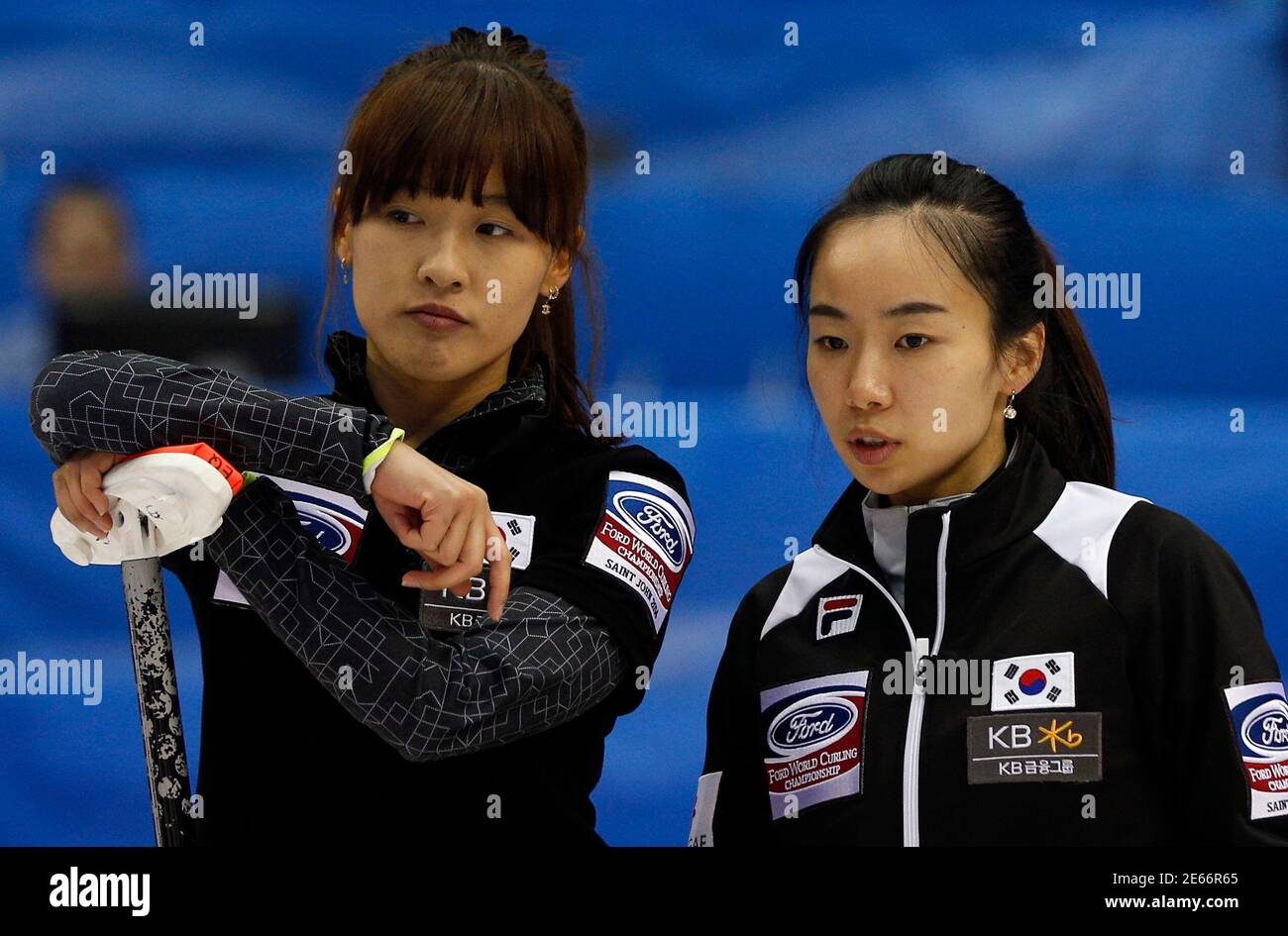 South Korea's third Gim Un-chi (L) and skip Kim Ji-sun look on during their  semi-final game against Switzerland at the World Women's Curling  Championships in Saint John, New Brunswick, March 22, 2014.