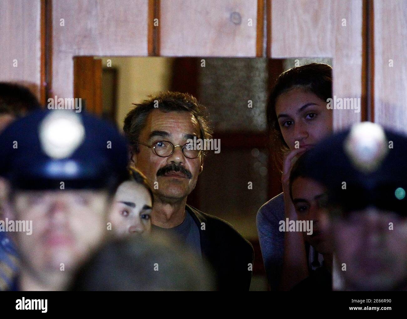 Gonzalo Garcia Barcha (L, rear), son of Colombian Nobel Prize laureate Gabriel Garcia Marquez, looks out of the door of Garcia Marquez home as a communique is being read to the media in Mexico City April 17, 2014. Garcia Marquez, the Colombian author whose beguiling stories of love and longing brought Latin America to life for millions of readers and put magical realism on the literary map, died on Thursday. He was 87. Fans will pay their last respects to him in the Palace of Fine Arts in Mexico City on Monday and he will be cremated in a private ceremony.  REUTERS/Edgard Garrido (MEXICO - Tag Stock Photo