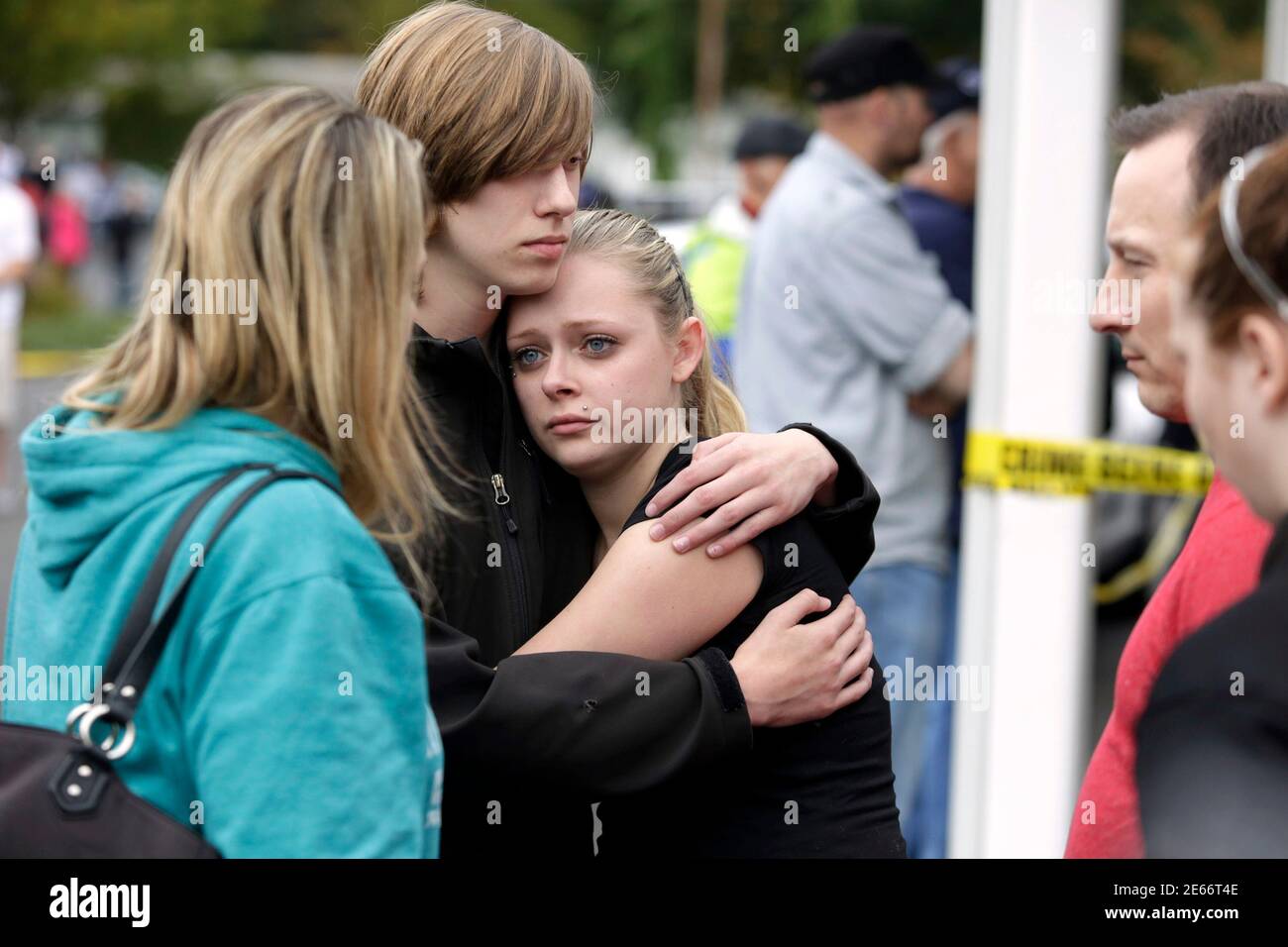 Students and family members reunite at Shoultes Gospel Hall after a student opened fire at Marysville-Pilchuck High School in Marysville, Washington October 24, 2014. The student opened fire in the cafeteria of Marysville-Pilchuck High School on Friday, killing a classmate and wounding at least four others before he was killed amid the chaos of students scrambling to safety, authorities said.  REUTERS/Jason Redmond   (UNITED STATES - Tags: CRIME LAW EDUCATION) Stock Photo