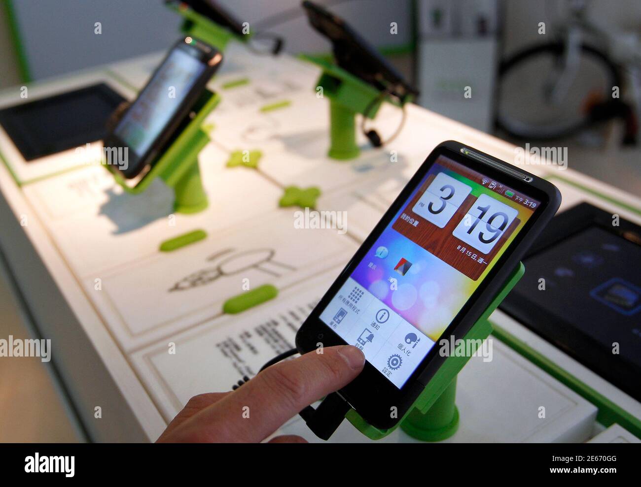 https www alamy com a man plays with a htc desire smartphone at a mobile phone shop in taipei august 15 2011 htc the worlds no 5 smartphone maker said on monday it would triple its china outlets to 2000 by end of this year from 650 now the company one of the largest manufacturers of googles android based devices is embroiled in an acrimonious patent war with apple and is also seeing its rapid growth slow in an increasingly competitive market reuterspichi chuang taiwan tags business image399680528 html
