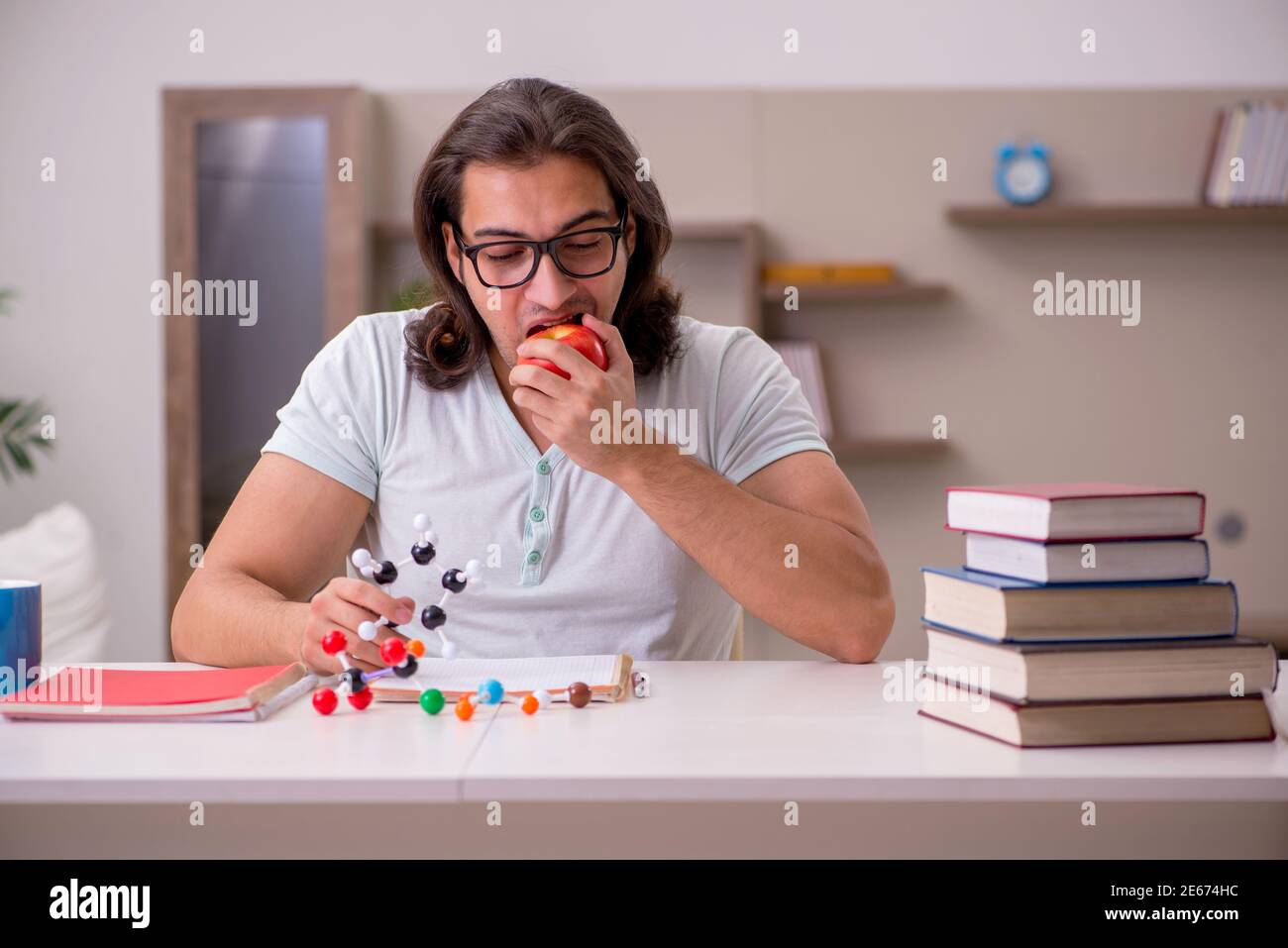 Young student preparing for exams at home Stock Photo - Alamy