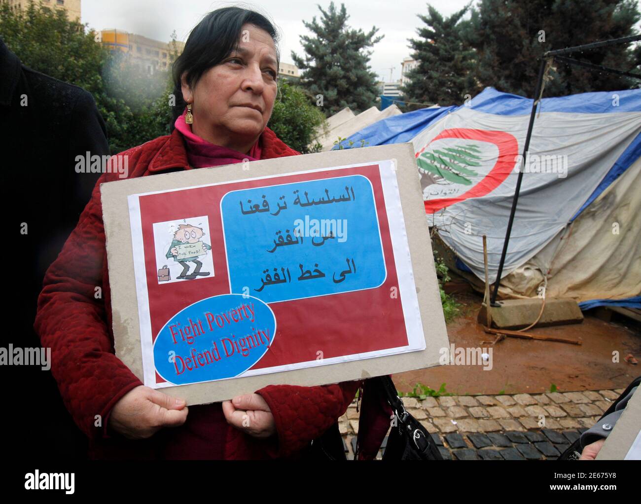 A teacher holds a sign during a protest at the Grand Serail, the government  headquarters in Beirut February 19, 2013. The teachers' Union Coordination  Committee (UCC) announced an open-ended strike from Tuesday