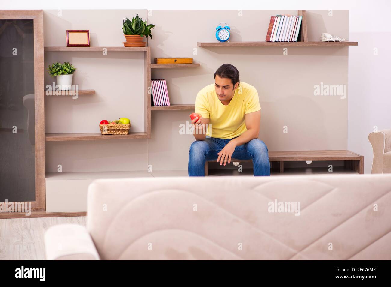 Young student boring at home during pandemic Stock Photo