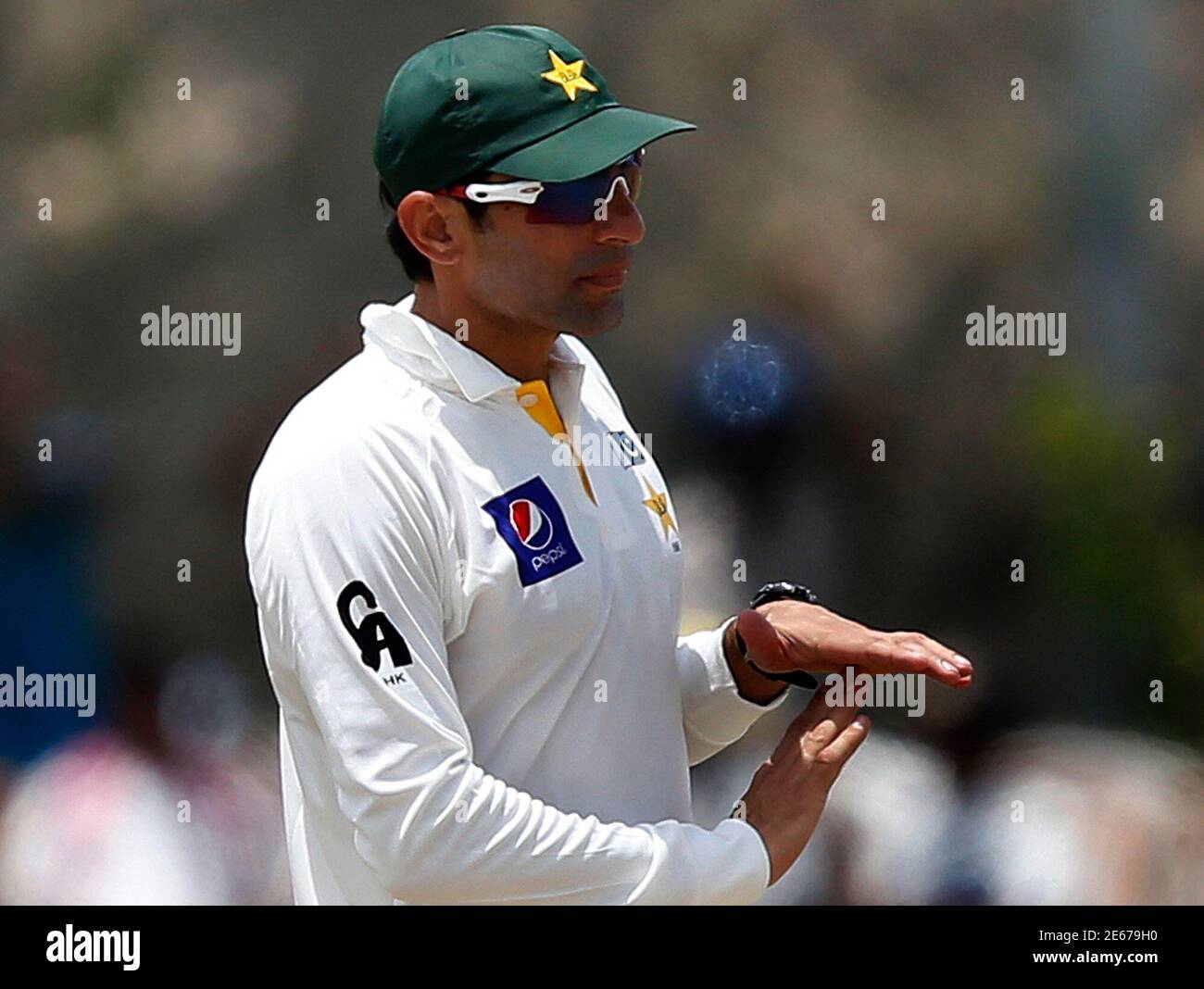 Pakistan's captain Misbah-ul-Haq signals the third umpire's decision for the unsuccessful wicket of Sri Lanka's Mahela Jayawardene (not pictured) during the third day of their first test cricket match in Galle August 8, 2014. REUTERS/Dinuka Liyanawatte (SRI LANKA - Tags: SPORT CRICKET) Stock Photo