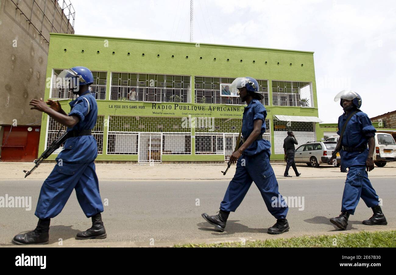Riot policemen walk outside the Radio Publique Africaine (RPA) broadcasting  studio in the capital Bujumbura, April 26, 2015. Burundi police and two  government ministers forcefully entered the RPA radio station on Sunday