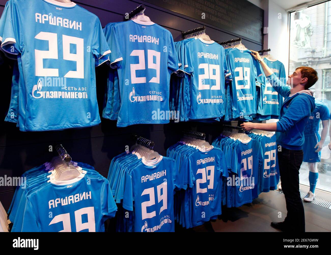 An employee arranges soccer jerseys of Zenit St. Petersburg's Andrei  Arshavin at a shop in St. Petersburg February 28, 2012. Zenit St Petersburg  have signed former striker Arshavin from Arsenal on loan