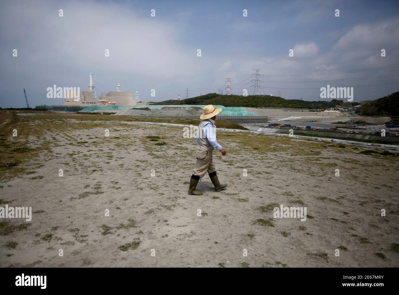 A Man Walks On A Sand Dune In Front Of Chubu Electric Power Co S Hamaoka Nuclear Power Station In Omaezaki Shizuoka Prefecture May 17 13 Chubu Electric Is Spending At Least 1 5