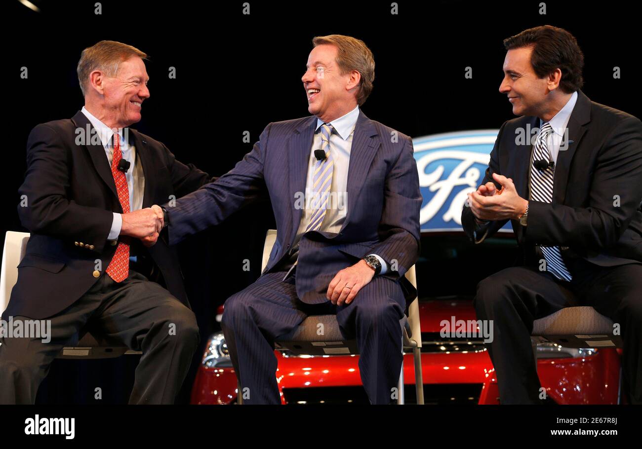 Ford Motor CEO and President Alan Mulally (L) shakes hands with Executive Chairman Bill Ford (C) after announcing COO Mark Fields will replace him as CEO on July 1 during a news conference in Dearborn, Michigan May 1, 2014. Mulally, whose retirement is effective July 1, said he would also leave the company's board but has not decided on his future plans. REUTERS/Rebecca Cook (UNITED STATES - Tags: TRANSPORT BUSINESS) Stock Photo