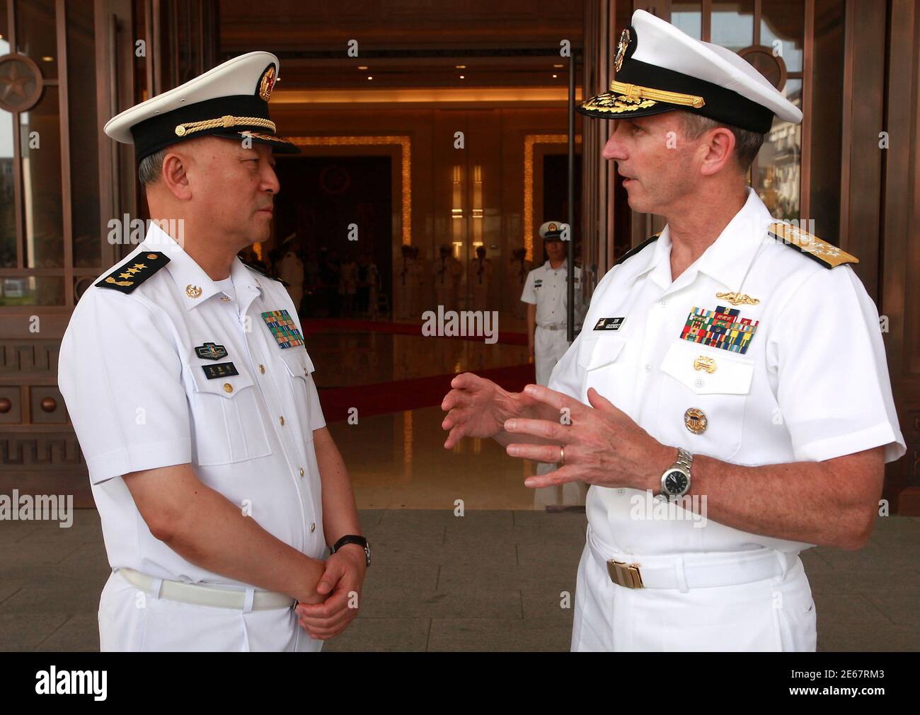U.S. Chief of Naval Operations Admiral Jonathan Greenert (R) talks with PLA  Navy Commander in Chief Admiral Wu Shengli during a welcoming ceremony at  the PLA Navy headquarters outside of Beijing July