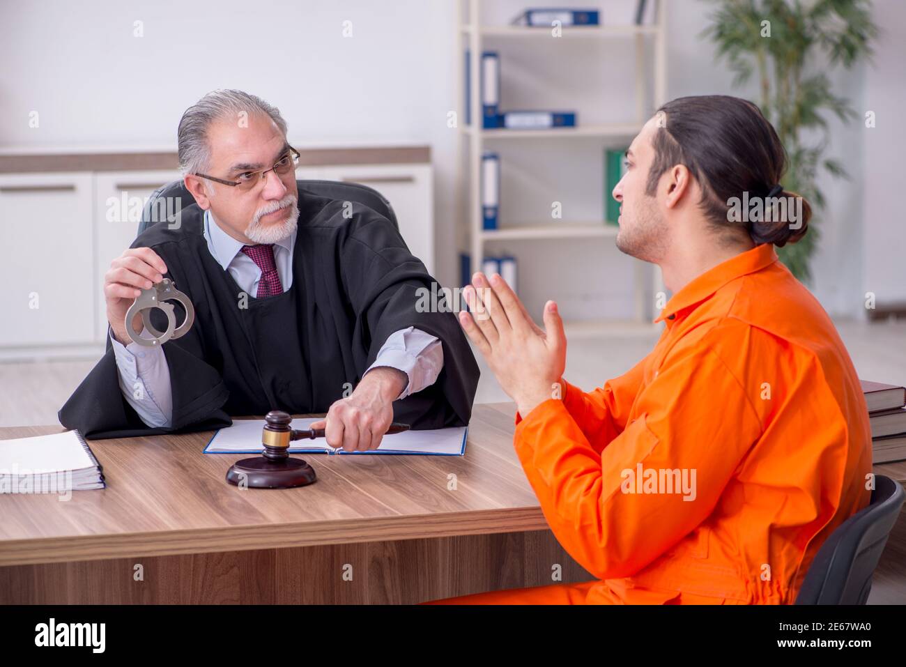 Old judge meeting with young captive in courthouse Stock Photo Alamy