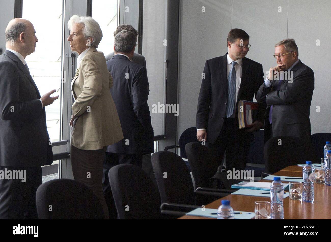 European Economic Commissioner Pierre Moscovici (L) talks with  International Monetary (IMF) Fund Managing Director Christine Lagarde (2nd  L) at a meeting with the European Central Bank and EU Commission officials  before the
