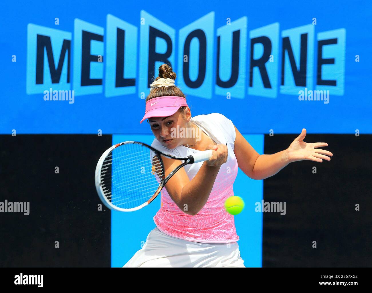 Sara Tomic of Australia hits a return to Tami Grende of Indonesia during their junior girls' singles first round match at the Australian Open tennis tournament in Melbourne January 25, 2015. Sara is the sister of Bernard Tomic, who will play Tomas Berdych of Czech Republic in their men's singles fourth round match later in the day. REUTERS/John French (AUSTRALIA  - Tags: SPORT TENNIS) Stock Photo