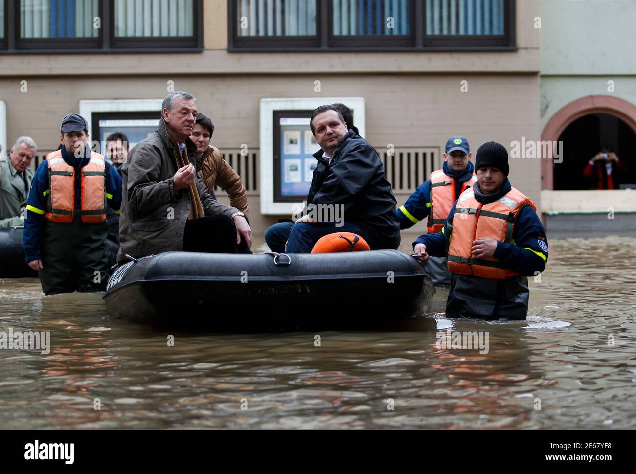 Baden-Wuerttemberg Premier Stefan Mappus (C) and Wertheim's Mayor Stefan  Mikulicz (4th L) sit in a rubber dinghy as they visit the flooded old town  of Wertheim, 100km (62 miles) south of Frankfurt,