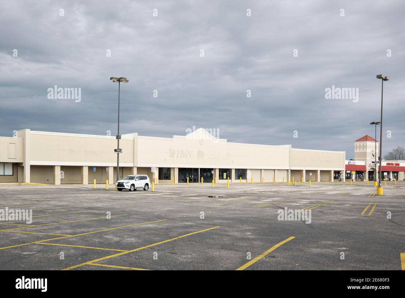 Front exterior of an empty store or store front or a closed retail shop in a shopping center in Montgomery Alabama, USA. Stock Photo