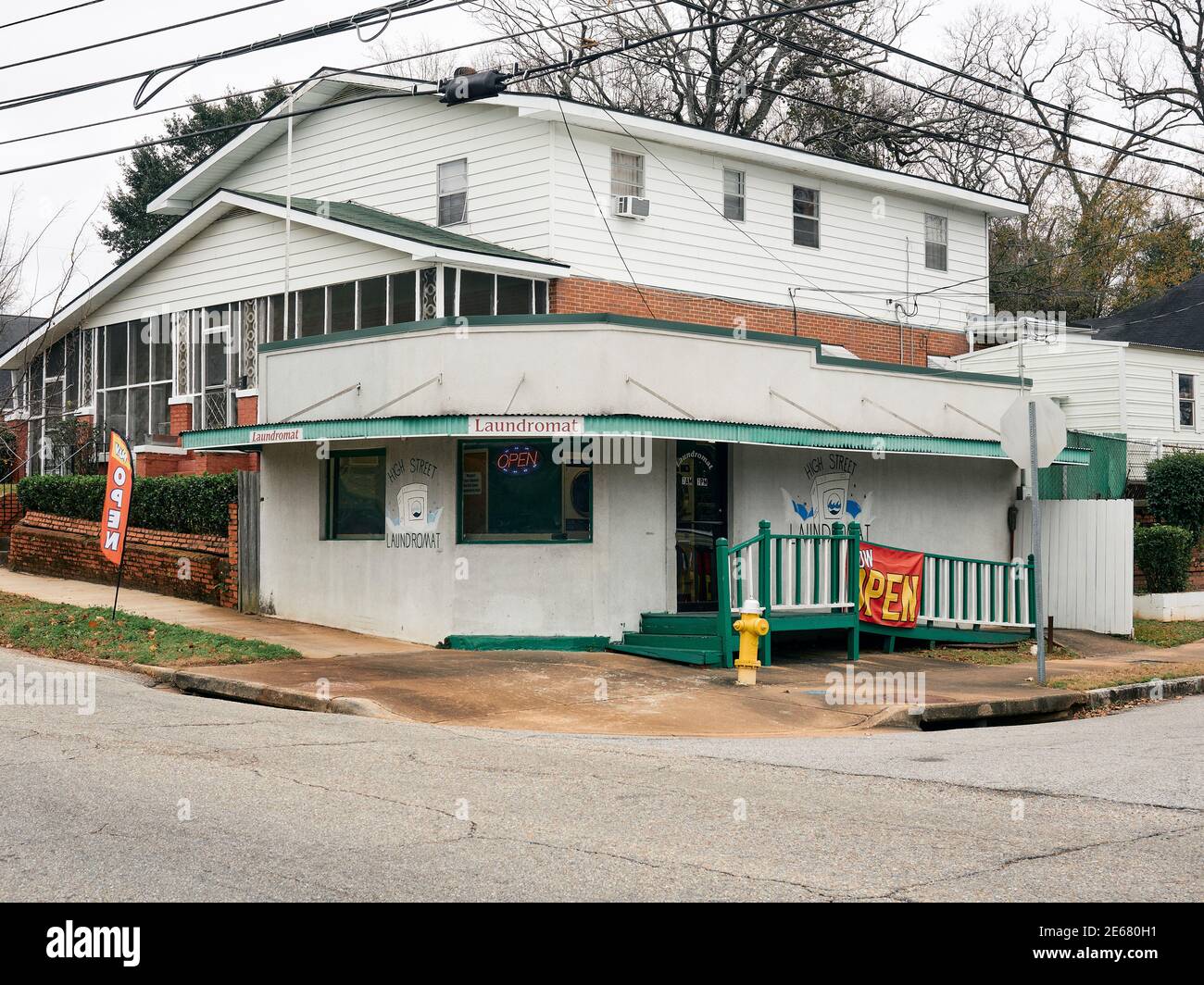 Front exterior entrance of a small laundromat in an old neighborhood in Montgomery Alabama, USA