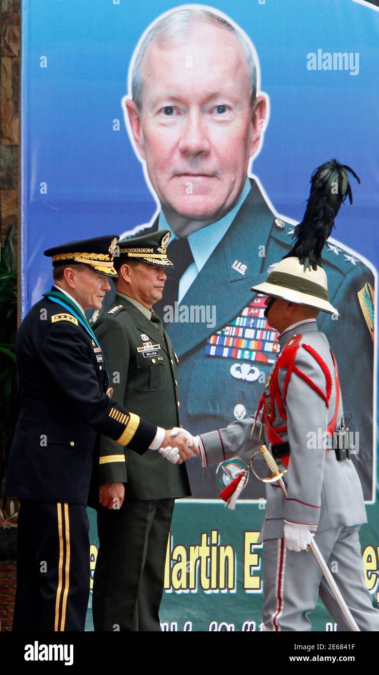 Chairman of the Joint Chiefs of Staff U.S. Army General Martin Dempsey (L) shakes hands with a Filipino soldier during a welcoming ceremony at the Philippine Armed Forces military headquarters in Quezon city, Metro Manila June 4, 2012. Dempsey met separately with President Benigno Aquino III and his counterpart Phillipine Armed Forces Chief of Staff Lieutenant General Jessie Dellosa, to discuss, among other topics, the tensions over the West Philippine Sea and standoff over the Scarborough Shoal with China, local media reported. At center is Lieutenant General Dellosa.  REUTERS/Erik De Castro  Stock Photo