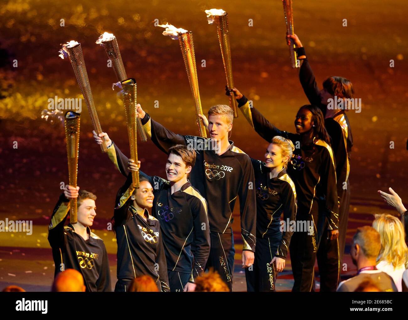 Seven final torchbearers prepare to light the Olympic Cauldron during the opening ceremony of the London 2012 Olympic Games at the Olympic Stadium July 27, 2012.       REUTERS/Mike Blake (BRITAIN  - Tags: SPORT OLYMPICS) Stock Photo