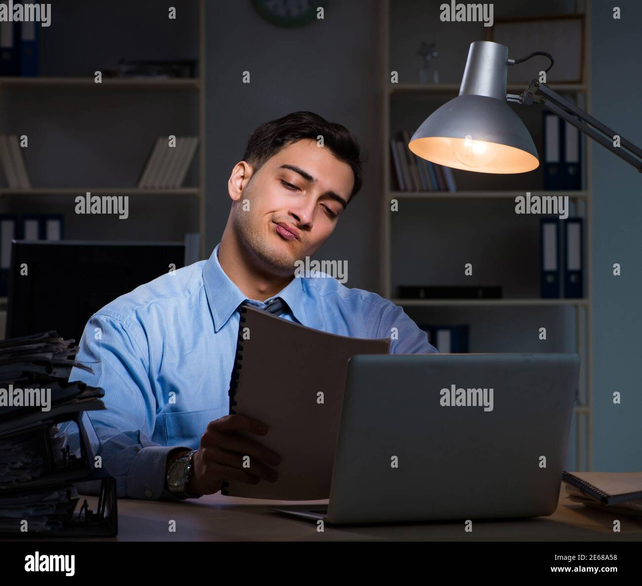 The employee working late at night at important report Stock Photo - Alamy
