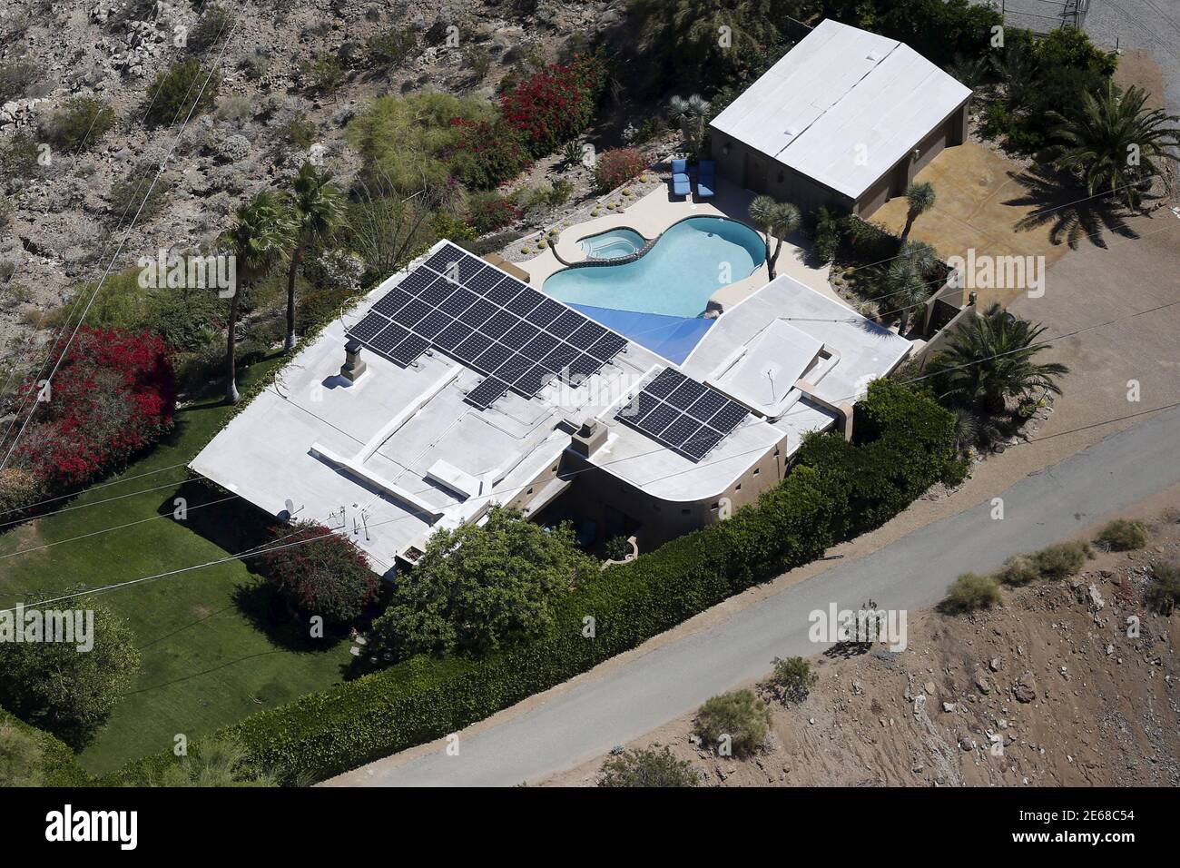 A home with rooftop solar panels is seen in La Quinta, California April 13, 2015. NRG Energy Inc  is turning California's devastating drought into a business opportunity. The power company, which has a small but fast-growing rooftop solar business, is giving customers in parts of the Golden State to option to bundle a solar energy system with products and services that will help them conserve water. Picture taken April 13, 2015. To match NRG ENERGY-WATER/ REUTERS/Lucy Nicholson Stock Photo