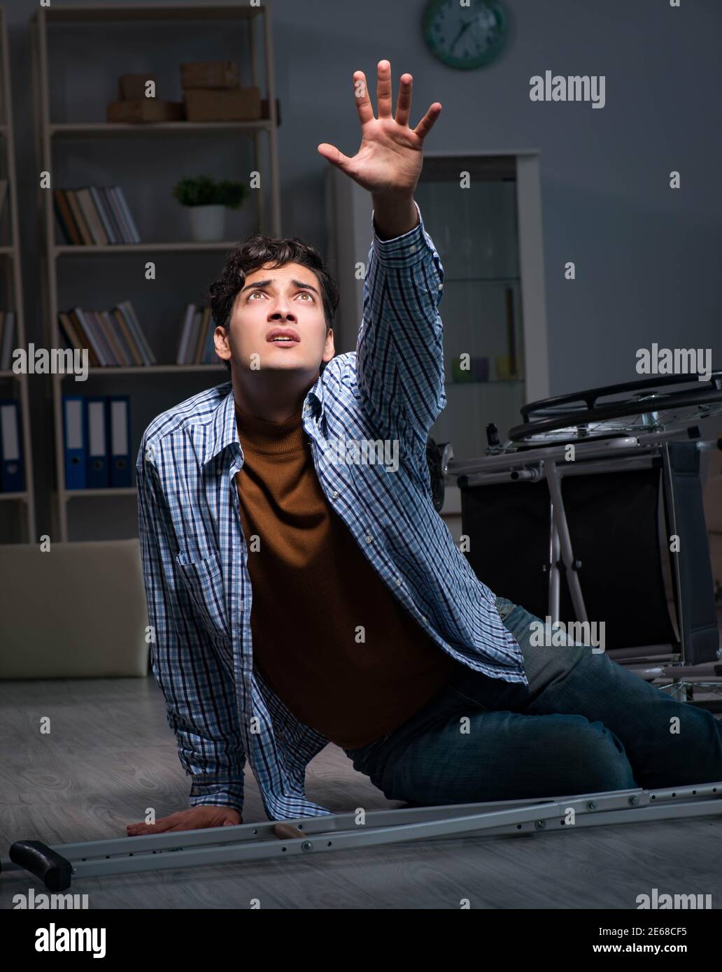 The man fell off wheelchair sitting on the floor Stock Photo - Alamy