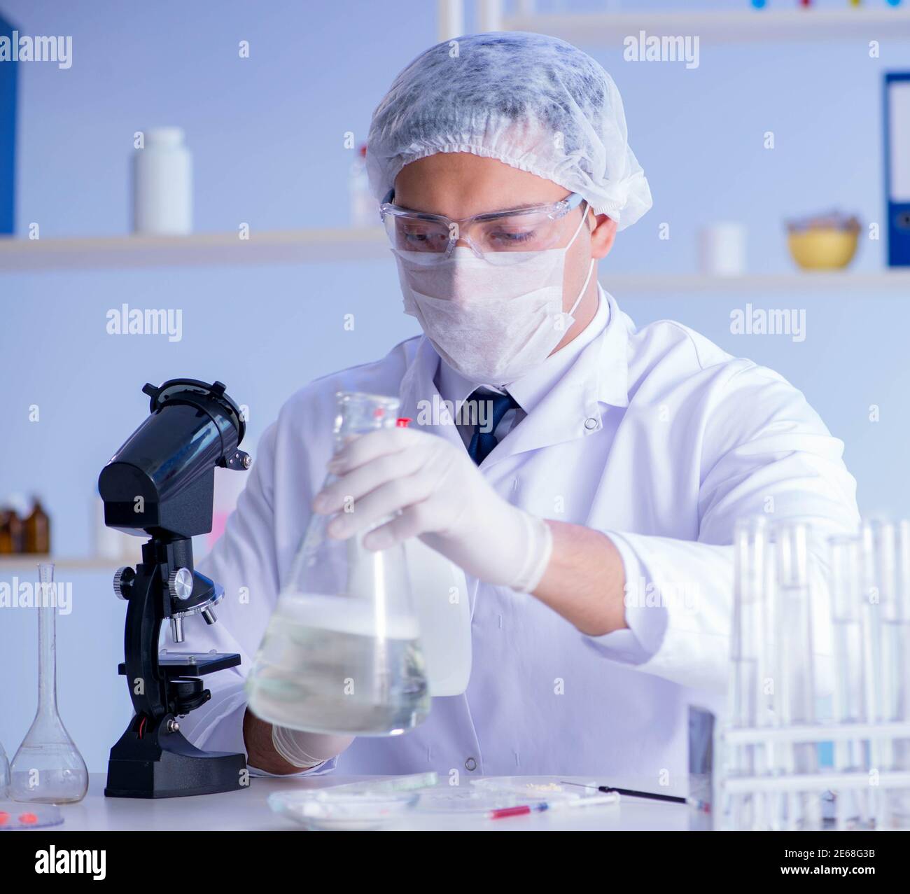 The man in the lab testing new cleaning solution detergent Stock Photo