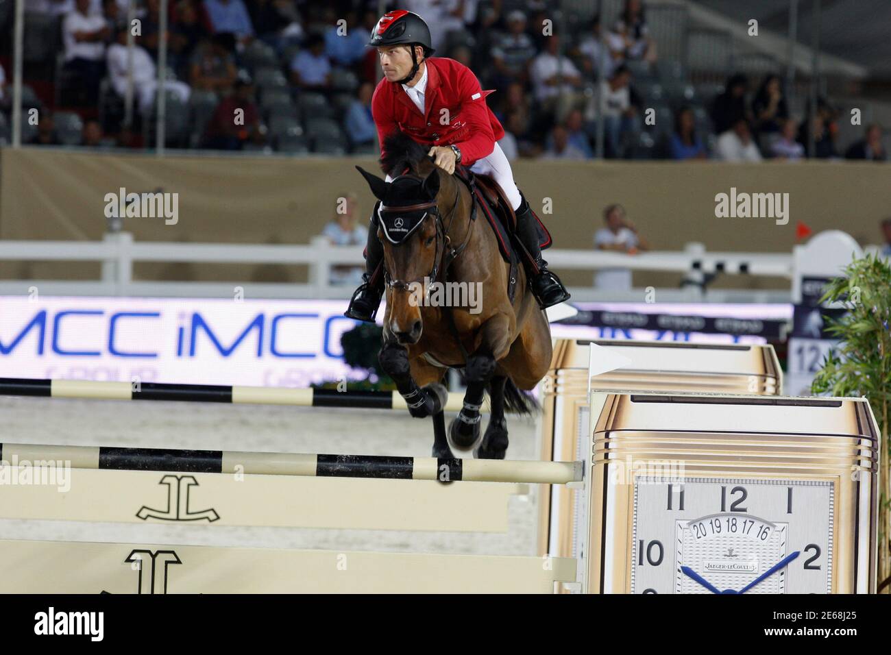 Switzerland?s Pius Schwizer clears a jump on his horse Carlina during the Global  Champions Tour in Abu Dhabi November 24, 2011. Picture taken November 24,  2011. REUTERS/Martin Dokoupil (UNITED ARAB EMIRATES -