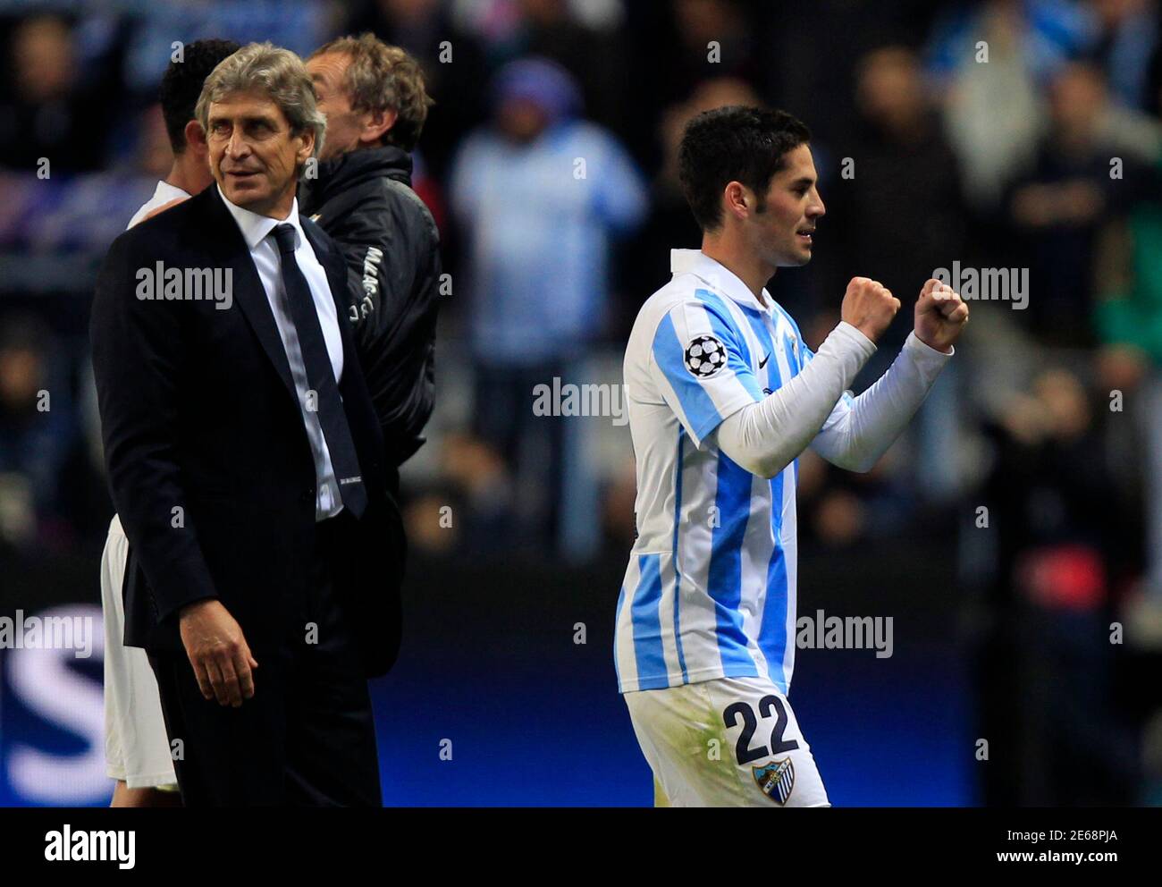 Malaga's Isco (R) celebrates next to his coach Manuel Pellegrini after  defeating Porto during their Champions League round of 16 second leg soccer  match at La Rosaleda stadium in Malaga, southern Spain