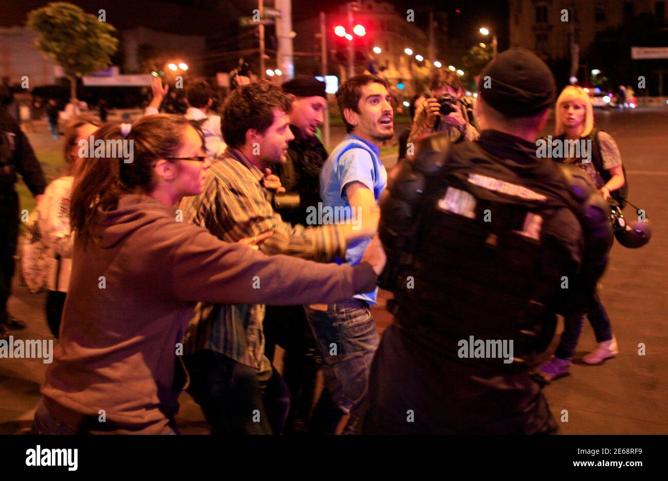 A demonstrator is briefly detained by gendarmes after an attempt to march on one of Bucharest's main boulevards September 6, 2013.   People in cities across Romania took to the streets against the Rosia Montana Gold Corporation venture, which aims to use cyanide to mine 314 tonnes of gold and 1,500 tonnes of silver, and protests have continued in the capital Bucharest ever since. Rosia Montana Gold Corporation believes Romania's parliament will vote in favour of the company's plan to open Europe's biggest open-cast gold mine in a small Carpathian town despite ongoing street protests against th Stock Photo