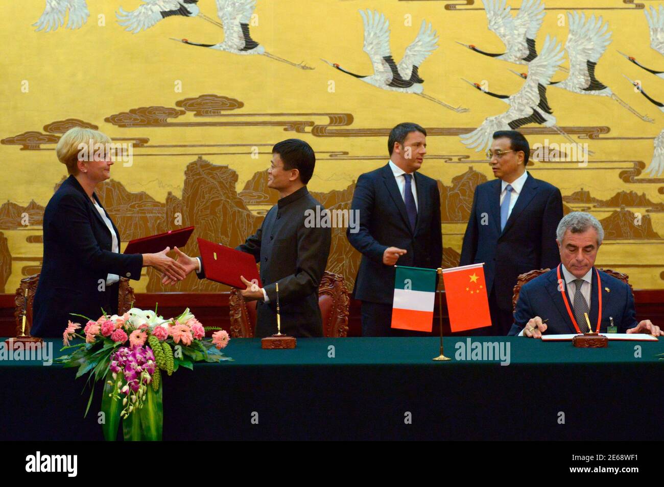 Italian Prime Minister Matteo Renzi (C) talks with Chinese Premier Li Keqiang (2nd R) as Alibaba CEO Ma Yun (2nd L) attends a signing ceremony at the Great Hall of the People in Beijing June 11, 2014. Renzi is visiting China from June 10 to 12. REUTERS/Wang Zhao/Pool (CHINA - Tags: POLITICS BUSINESS) Stock Photo
