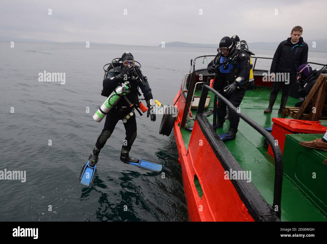 A diver jumps into the water, ahead of a dive on the wreck of a German WWI warship at Scapa Flow in the Orkney Islands, Scotland May 7, 2014. During both World Wars, Scapa Flow was an important British naval base, and the site of significant loss of life. Following the end of World War One, 74 German warships were interned there, and on June 21, 1919 most were deliberately sunk, or scuttled, at the orders of German Rear Admiral Ludwig Von Reuter, who mistakenly thought that the Armistice had broken down and wanted to prevent the British from using the ships. Now Scapa Flow is a popular site fo Stock Photo
